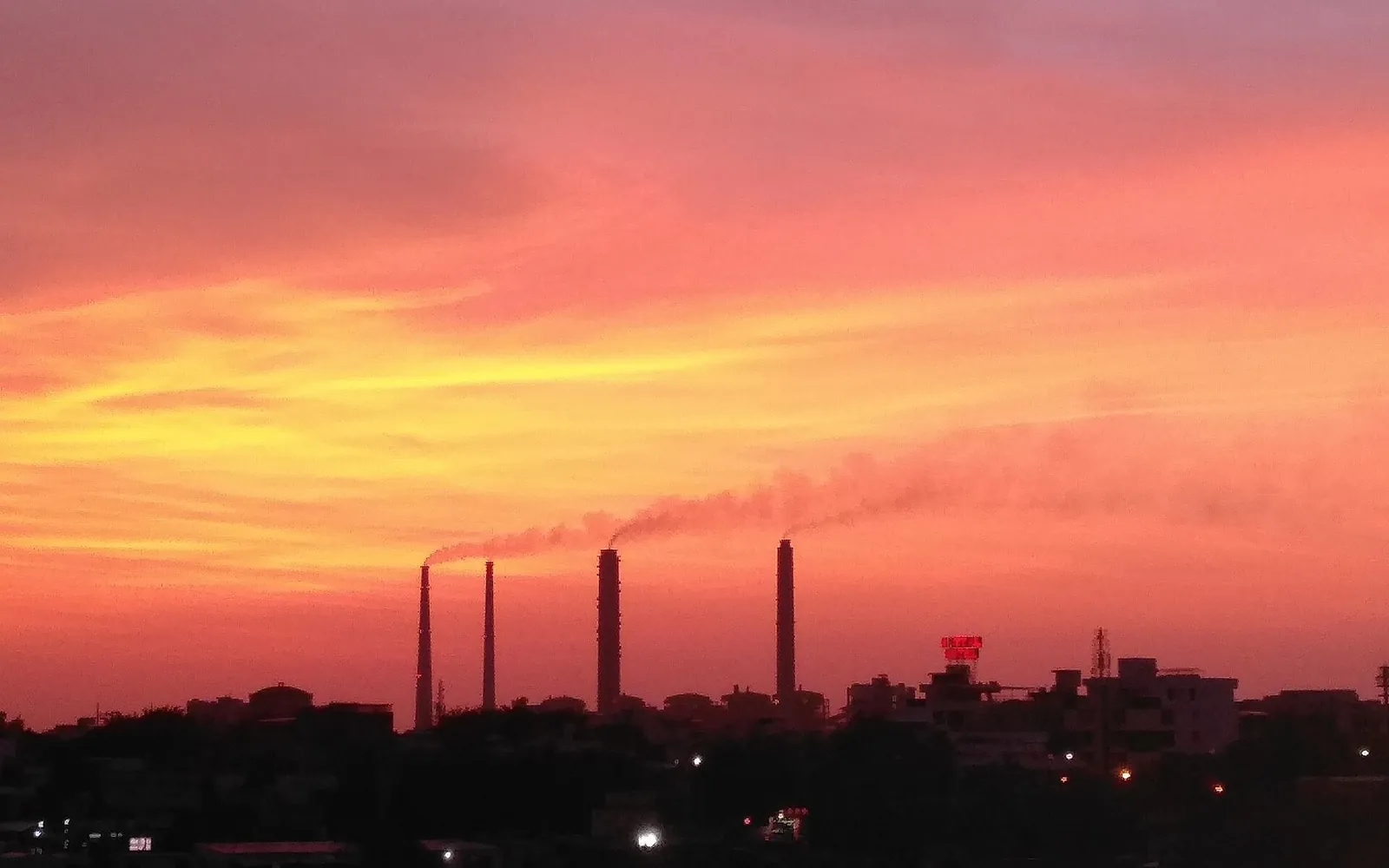 Orange evening sky over Kota with power station chimneys on the skyline