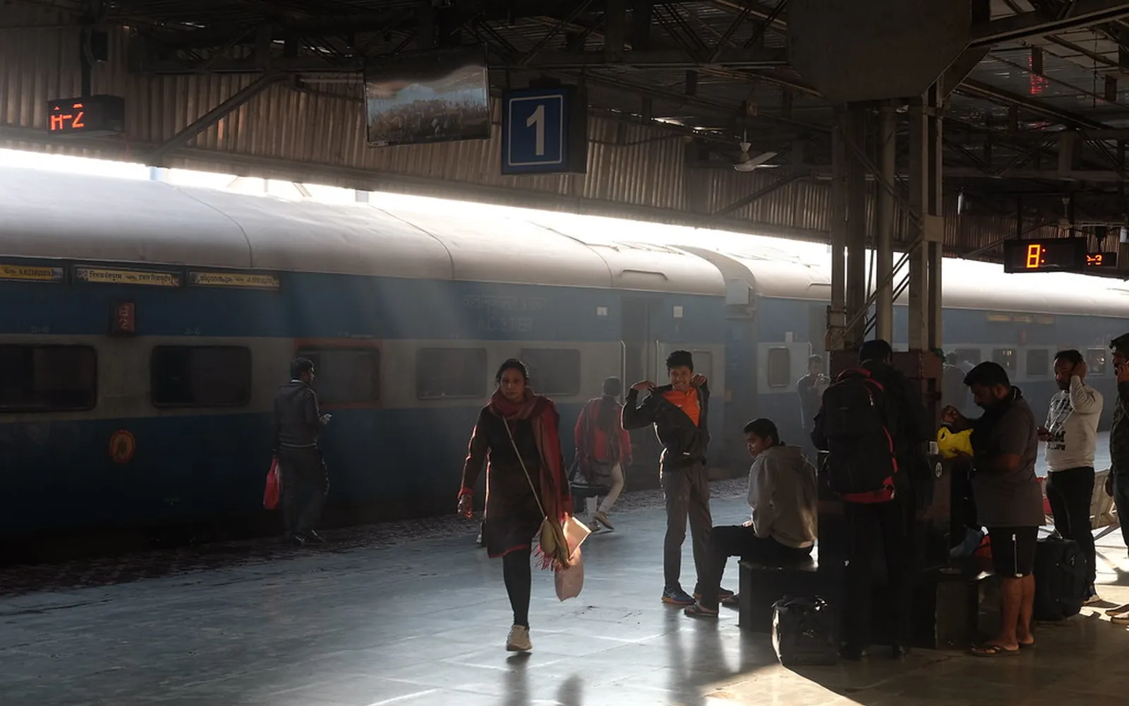 Passengers on a platform beside a train at Kota railway station